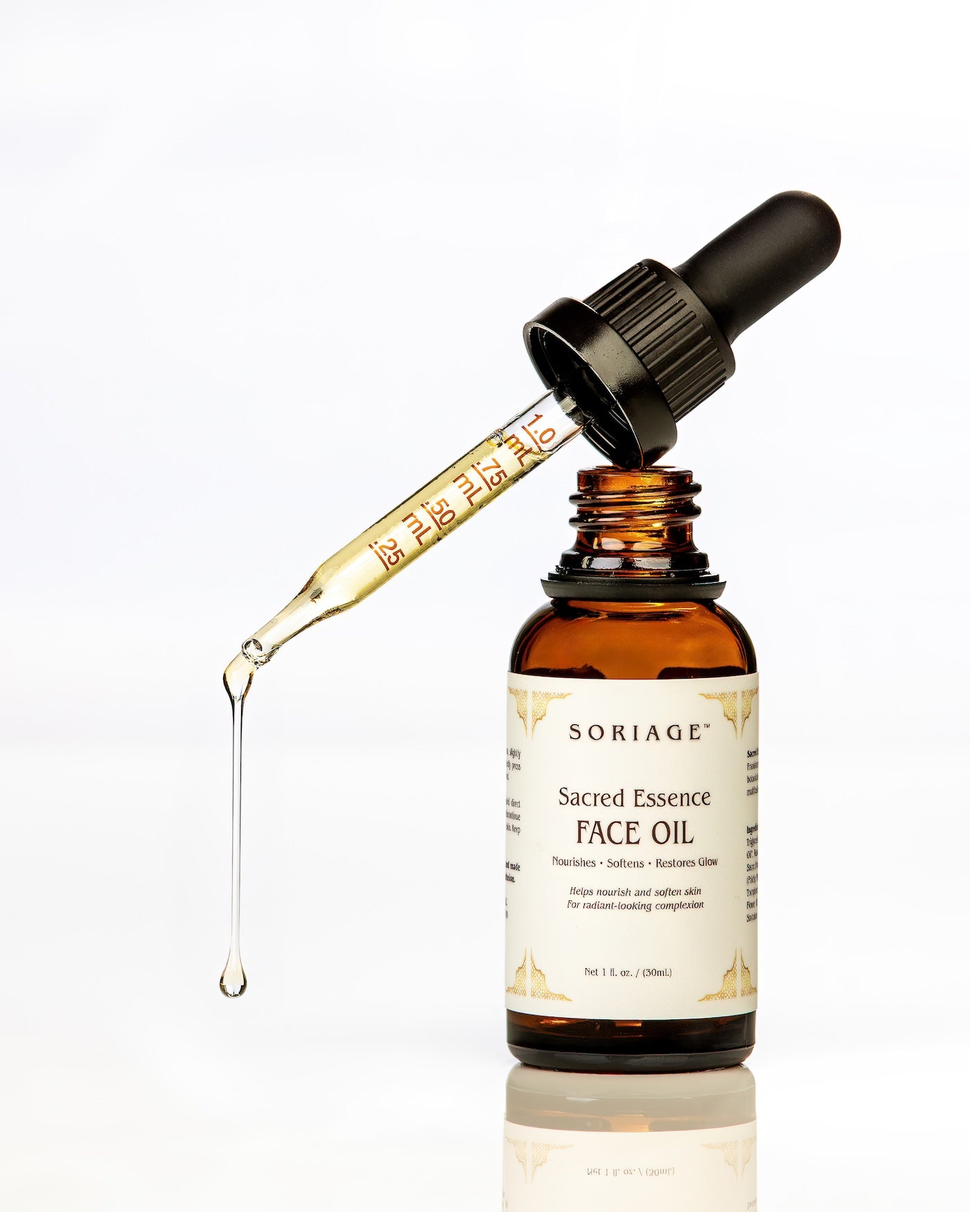 Sacred Essence Face Oil in open dropper bottle on white background